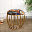 Abstract geometric suede stool with metallic print, gold cage base.