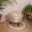 Embroidered yellow tree design on upholstered wooden stool