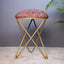 Rust floral suede fabric stool with metallic cross-style legs