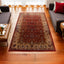 Traditional Persian wool rug with intricate patterns in rich red tones