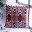 Embroidered red cotton cushion cover with decorative patterns