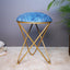 Blue floral suede stool with a metallic cross base, elegant design