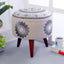 Embroidered grey wooden stool with intricate fabric detailing