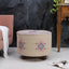 Embroidered pink upholstered stool with elegant detailing