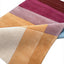 Hand-tufted wool rug with geometric design in warm earthy tones