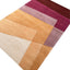 Hand-tufted wool rug with geometric design in warm earthy tones