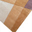 Hand-tufted wool rug with geometric design in warm earthy tones