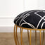 Black abstract fabric stool with a gold cage-style metallic base